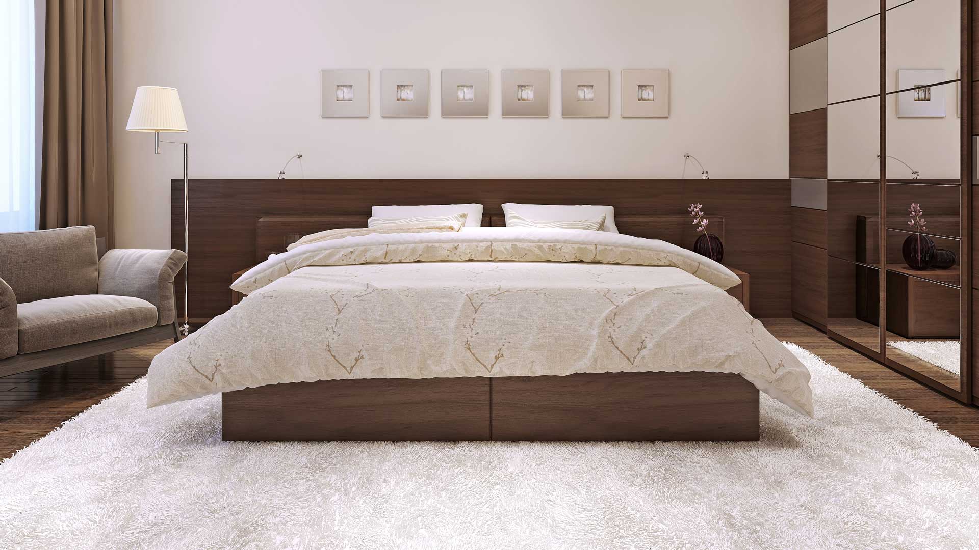 A bright bedroom with a soft area rug