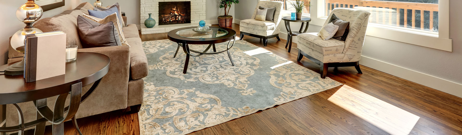 A light patterned rug in a living room with a fireplace
