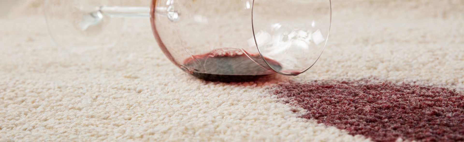 Red wine spilled on a cream rug